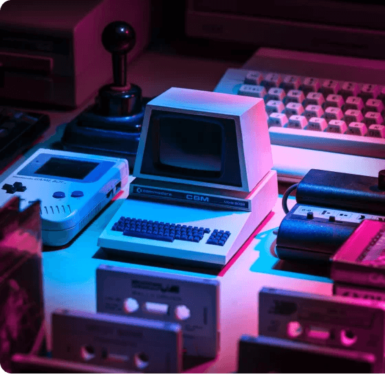Picture showing a Commodore, a Joystick, a GameBoy, Cassetts and a Keyboard