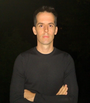 Prof. Dr. Jonas Polfuß, Marketing Professor, posing in front of a black background