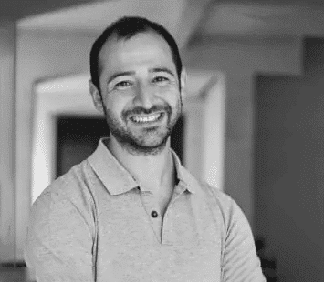 Influencer Marketing Experte Kouscha Arzideh lächelt auf einem schwarz-weiß Bild