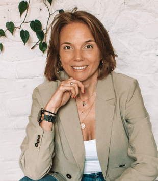 Viktoria Egger, Influencer-Marketing Consultant, posiert für ein schönes Foto vor einer weißen Ziegelwand